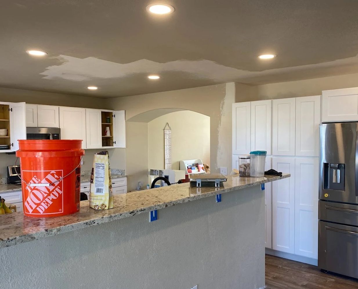 Recessed lighting installed across a kitchen ceiling during a remodel by Silverman Electric