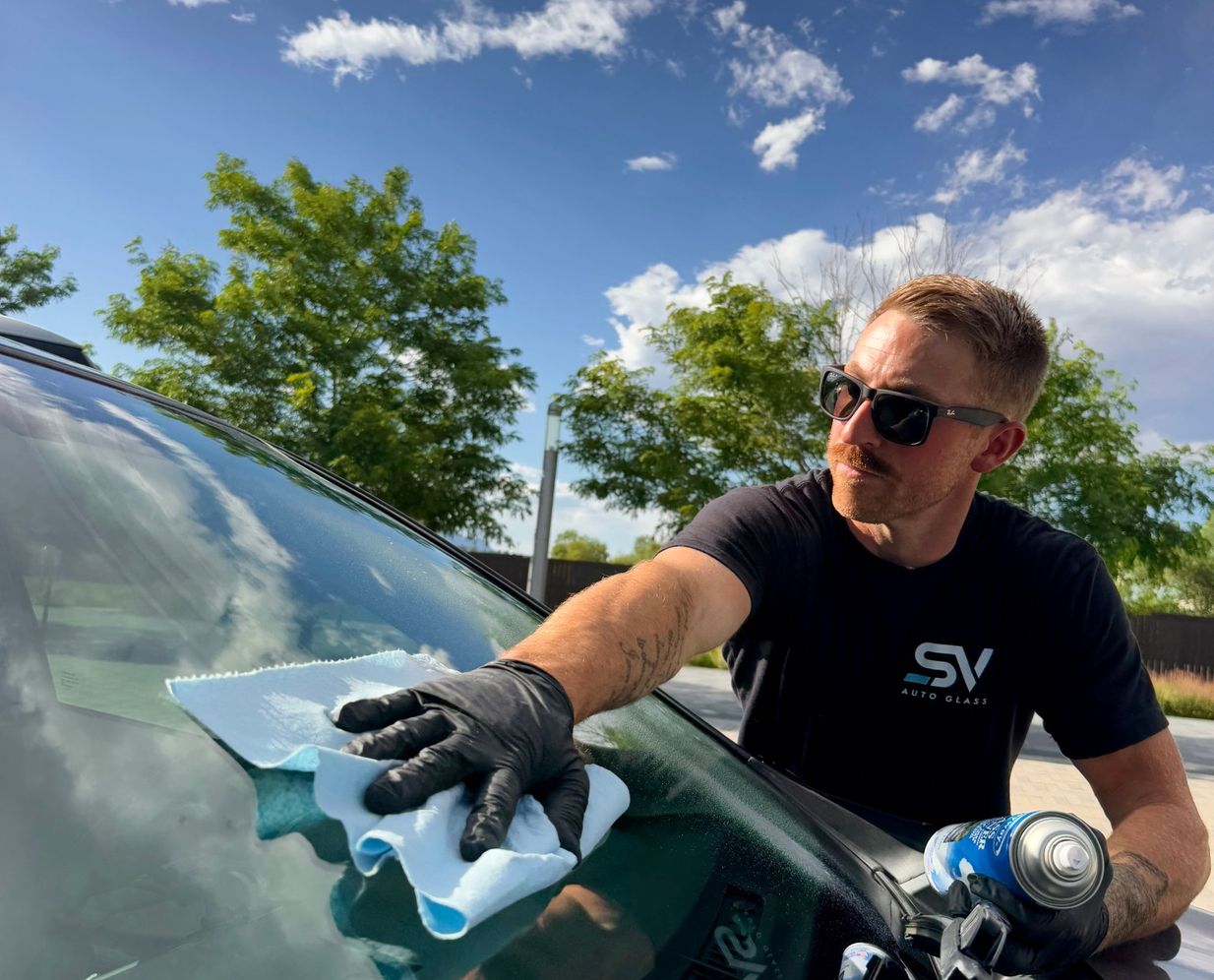 Shattered Vision Auto Glass technician finishing a windshield replacement in Colorado Springs